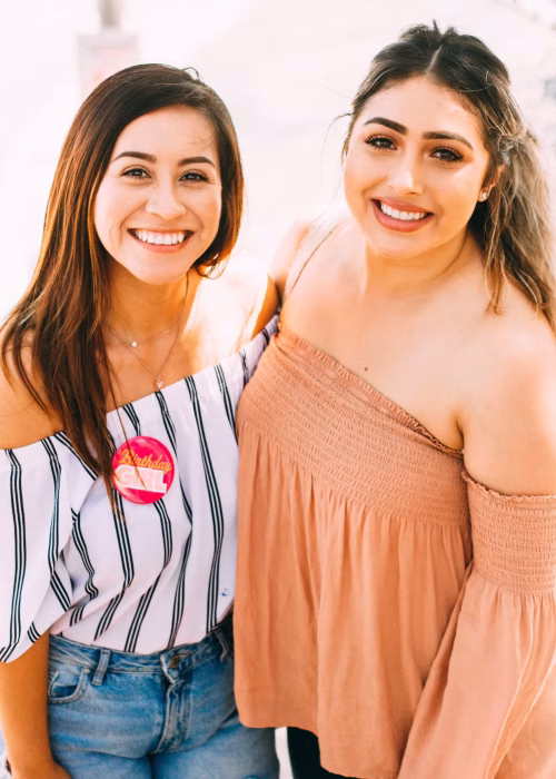 Two young women showcasing bright, healthy white smiles after a professional teeth whitening treatment.