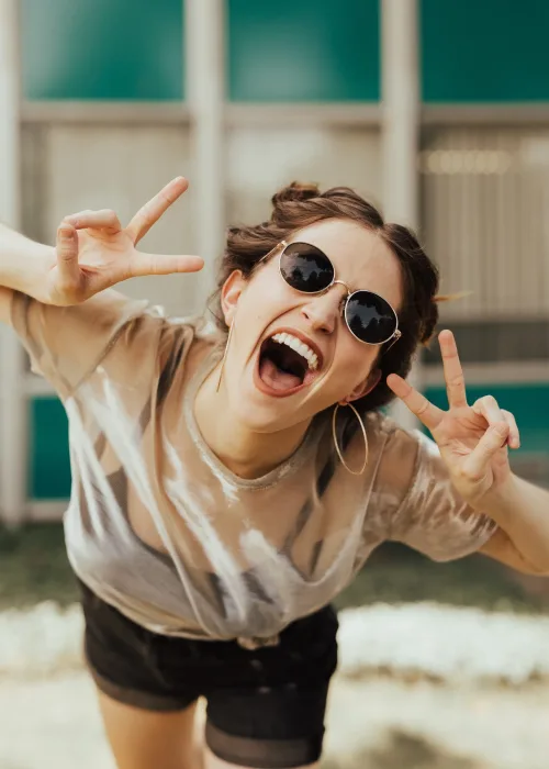 A happy, pain-free patient smiling after successful treatment for night teeth grinding.