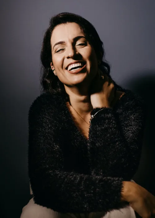 Close-up portrait of a woman smiling confidently with brightened teeth.