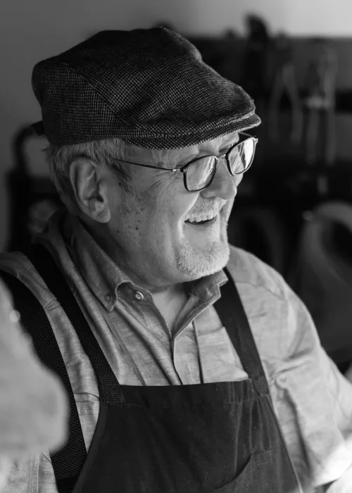 A happy senior man smiling after receiving custom partial dentures to restore his natural smile.